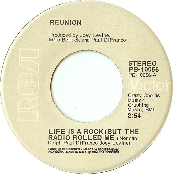 Reunion (3) : Life Is A Rock (But The Radio Rolled Me) (7", Single, Ind)